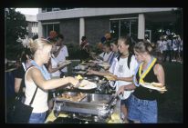 Students getting food at a luau party